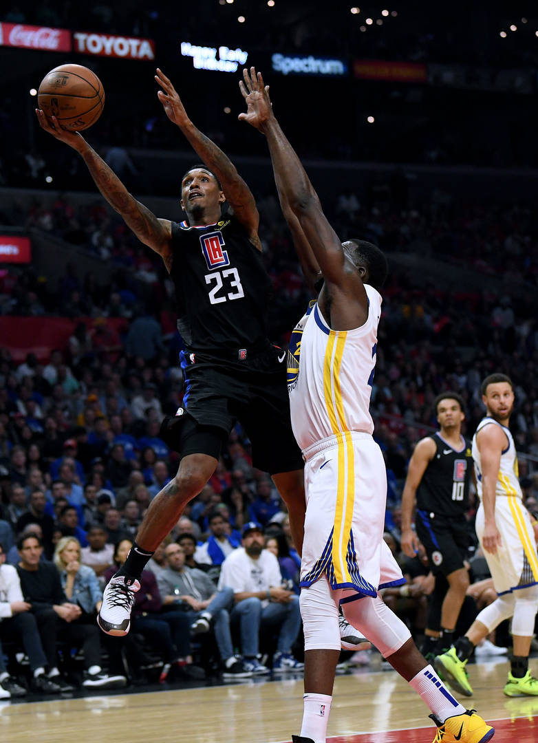 Lou Williams #23 of the LA Clippers scores around Draymond Green #23 of the Golden State Warriors in a 129-110 Clipper loss during Game Six of Round One of the 2019 NBA Playoffs at Staples Center on April 26, 2019 in Los Angeles, California.